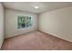 Well-lit bedroom features neutral walls, a window, and plush carpeting at 1340 Apple Blossom Dr, Cumming, GA 30041