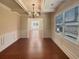 Formal dining room featuring coffered ceiling, wainscoting, hardwood floors and natural light at 1340 Apple Blossom Dr, Cumming, GA 30041