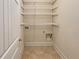 Empty laundry room area with tile flooring and wire shelving at 1340 Apple Blossom Dr, Cumming, GA 30041