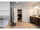 Expansive bathroom featuring dual vanity, granite countertops, and decorative wall lighting at 165 Ruby Ln, Mcdonough, GA 30252