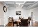 Bright dining room boasts coffered ceilings, wainscoting, and a modern round wood table at 165 Ruby Ln, Mcdonough, GA 30252