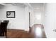 Bright hallway with hardwood floors and wainscoting leads to a white front door at 165 Ruby Ln, Mcdonough, GA 30252