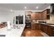 Spacious kitchen with a large marble countertop island, modern appliances, and elegant wooden cabinetry at 165 Ruby Ln, Mcdonough, GA 30252