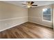 Bedroom features hardwood floors, tan walls, and a window at 166 Floresta Dr, Mcdonough, GA 30252