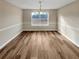 A spacious dining room featuring hardwood floors, chandelier and a large window at 166 Floresta Dr, Mcdonough, GA 30252