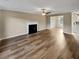 Well-lit living room featuring a fireplace and hardwood floors at 166 Floresta Dr, Mcdonough, GA 30252