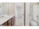 Bright bathroom featuring wood cabinets, modern fixtures, and tile floor at 3137 Primrose St, Douglasville, GA 30135