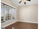 Cozy bedroom featuring hardwood floors, a ceiling fan, and a large window for natural light at 3137 Primrose St, Douglasville, GA 30135