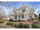 Two-story home with inviting front porch, complemented by lush landscaping and mature trees at 3137 Primrose St, Douglasville, GA 30135