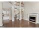 Open-concept living room with a fireplace, staircase, and a view into the kitchen at 3137 Primrose St, Douglasville, GA 30135