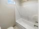 Bright bathroom with tub and shower combination and a small window at 3308 Steeple Chase Sw Way, Conyers, GA 30094