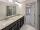 Bathroom featuring dual sinks with granite countertops and modern fixtures at 3308 Steeple Chase Sw Way, Conyers, GA 30094