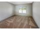 An empty carpeted bedroom featuring a large window at 3308 Steeple Chase Sw Way, Conyers, GA 30094