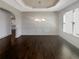 Dining room with hardwood floors and a large window at 3308 Steeple Chase Sw Way, Conyers, GA 30094