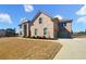 Spacious two-story brick home with arched entryway, three car garage, and manicured front lawn at 3308 Steeple Chase Sw Way, Conyers, GA 30094