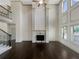 Living room featuring a fireplace, two-story ceilings, hardwood floors, and natural light at 3308 Steeple Chase Sw Way, Conyers, GA 30094