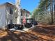 Spacious backyard patio perfect for outdoor entertaining, adjacent to the home and surrounded by trees at 3578 Willow Spring Ct, Decatur, GA 30034