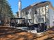 Side view of a patio featuring an outdoor dining set and seating, extending from the house into the yard at 3578 Willow Spring Ct, Decatur, GA 30034