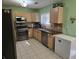 Well-lit kitchen featuring stainless steel appliances, granite countertops, and ample cabinet space at 3578 Willow Spring Ct, Decatur, GA 30034