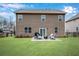 Well-manicured backyard featuring a patio with seating and a fire pit for outdoor entertaining at 4080 Huron Dr, Cumming, GA 30028