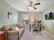 Bright bedroom featuring neutral walls, a ceiling fan, and a comfortable couch at 4080 Huron Dr, Cumming, GA 30028