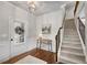 Foyer featuring hardwood floors, staircase, and stylish console table with decor at 4080 Huron Dr, Cumming, GA 30028