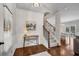 Entryway featuring hardwood floors, staircase, and stylish console table with decor at 4080 Huron Dr, Cumming, GA 30028