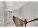 Hallway with neutral carpet and wooden railing at 4080 Huron Dr, Cumming, GA 30028