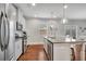 The kitchen features stainless steel appliances, white cabinets, and a kitchen island at 4080 Huron Dr, Cumming, GA 30028