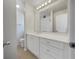 Well-lit bathroom with white cabinets, a large mirror and a white countertop, offering a clean aesthetic at 51 Lost Meadows Dr, Dallas, GA 30157