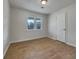This bedroom features wood-look flooring, a window, and neutral decor at 51 Lost Meadows Dr, Dallas, GA 30157