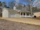 Charming single-story home with a covered front porch, attached garage, and well-maintained landscaping at 51 Lost Meadows Dr, Dallas, GA 30157