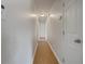 Neutral-toned hallway featuring wood floors and white doors, leading to various rooms in the home at 51 Lost Meadows Dr, Dallas, GA 30157