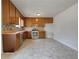 Kitchen with wood cabinets, stainless steel appliances, and tile backsplash with a neutral color palette at 51 Lost Meadows Dr, Dallas, GA 30157