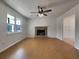 Bright living room with hardwood floors, stone fireplace, and modern ceiling fan fixture at 51 Lost Meadows Dr, Dallas, GA 30157