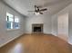 Living room with hardwood floors, a stone fireplace, ceiling fan and natural light from a large window at 51 Lost Meadows Dr, Dallas, GA 30157