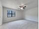 Carpeted main bedroom features a ceiling fan and large window to provide ample lighting at 51 Lost Meadows Dr, Dallas, GA 30157