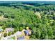 Wide aerial view of a house in a lush forest, marked with a yellow pin at 6690 Bridge Brook Ovlk, Cumming, GA 30028