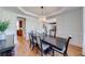 Well-lit dining room with hardwood floors, elegant chandelier, and views of the backyard at 6690 Bridge Brook Ovlk, Cumming, GA 30028