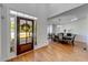 Bright foyer leading to an elegant dining room with hardwood floors and wainscoting at 6690 Bridge Brook Ovlk, Cumming, GA 30028