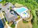 Aerial view of community pool and clubhouse with many lounge chairs surrounding it at 6690 Bridge Brook Ovlk, Cumming, GA 30028