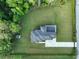 Expansive estate with lush greenery, modern architecture and a private driveway, all captured from an aerial perspective at 2940 Old Peachtree Rd, Dacula, GA 30019