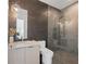 Modern bathroom featuring a glass-enclosed shower, textured tile wall, and vanity with a vessel sink at 2940 Old Peachtree Rd, Dacula, GA 30019