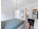 Calm bedroom featuring light wood floors, and an open doorway leading to a walk-in closet and bathroom at 2940 Old Peachtree Rd, Dacula, GA 30019