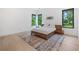 Modern bedroom featuring a sleek platform bed, minimalist decor, and bright natural light from the window at 2940 Old Peachtree Rd, Dacula, GA 30019