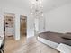 Modern bedroom with hardwood floors, minimalist decor, walk-in closet and unique ceiling light fixture at 2940 Old Peachtree Rd, Dacula, GA 30019
