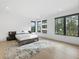 Bright bedroom featuring large windows, hardwood floors, and a minimalist design offering a serene and inviting space at 2940 Old Peachtree Rd, Dacula, GA 30019