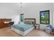 Well-lit bedroom with hardwood floors, featuring a built-in desk, and a comfortable space for rest and study at 2940 Old Peachtree Rd, Dacula, GA 30019