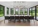 Elegant dining room with a long table, modern chairs, and contemporary lighting at 2940 Old Peachtree Rd, Dacula, GA 30019