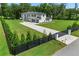 Gated estate with a long driveway, modern home design, and lush landscaping at 2940 Old Peachtree Rd, Dacula, GA 30019